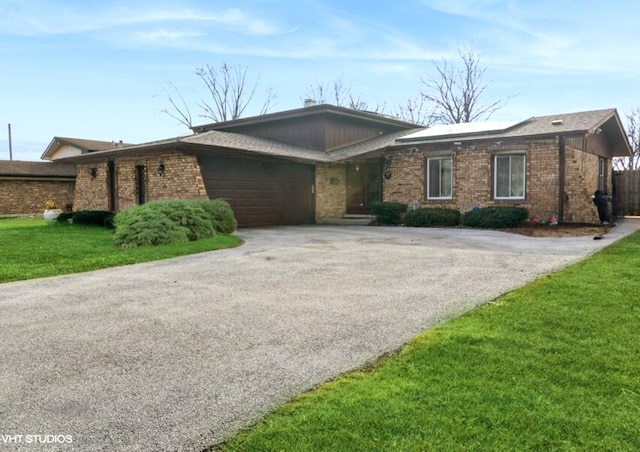 single story home with a front yard and a garage