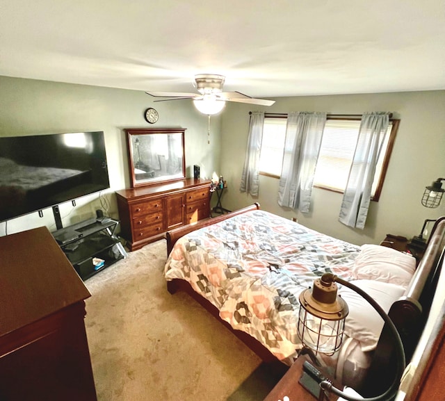 bedroom featuring ceiling fan and carpet