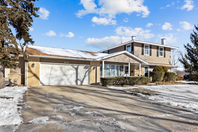 view of front of property with concrete driveway and an attached garage