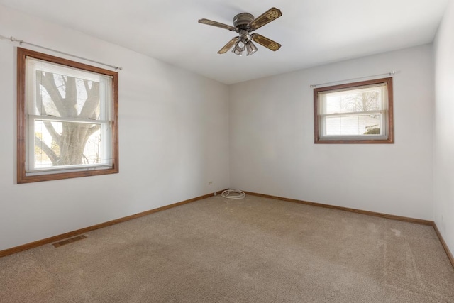 empty room with ceiling fan and carpet