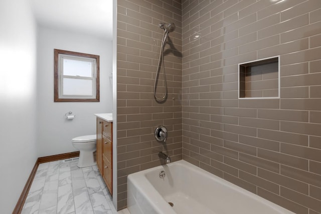 full bathroom with toilet, vanity, and tiled shower / bath combo