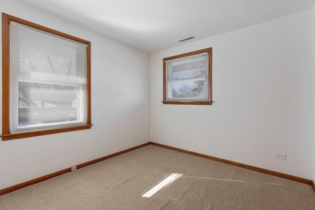 carpeted empty room with a wealth of natural light