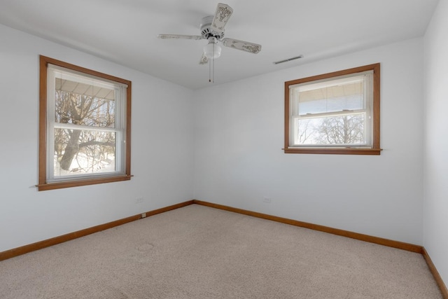 carpeted empty room featuring ceiling fan