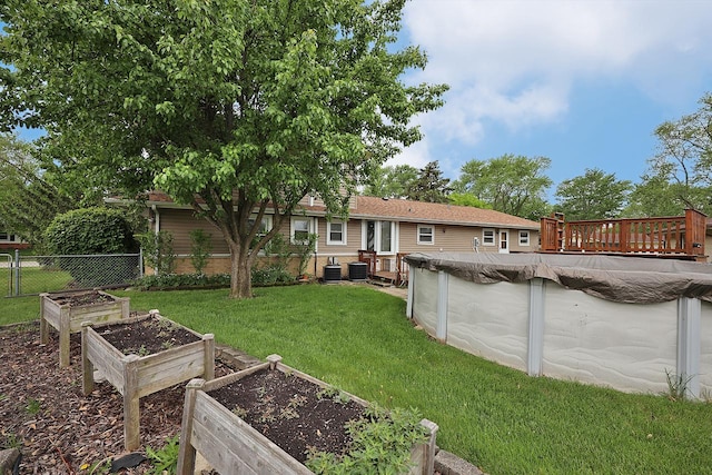 1141 Hartford Ln, Elk Grove Village, IL 60007 - view of yard with a vegetable garden, central air condition unit, and a wooden deck