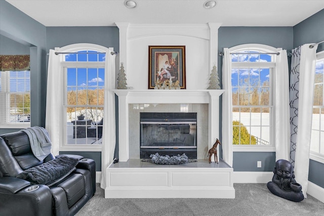 living room with carpet floors and a fireplace