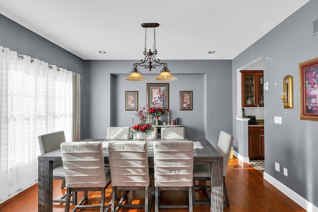 dining area with dark wood-type flooring