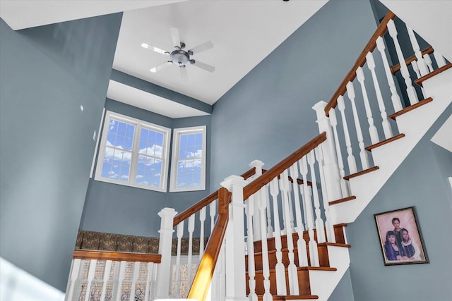 staircase with ceiling fan and plenty of natural light