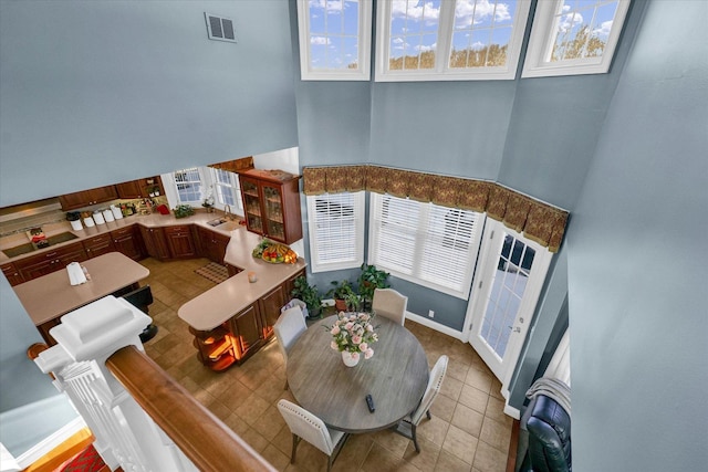 dining area featuring a high ceiling and light tile patterned floors