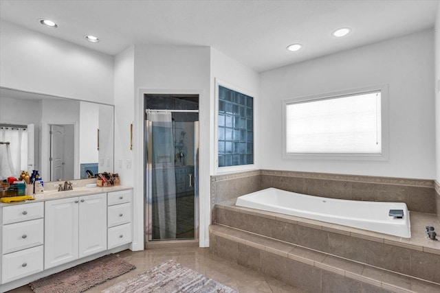 bathroom with vanity and plus walk in shower