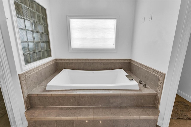 bathroom with tiled tub