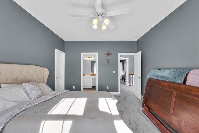 carpeted bedroom featuring ceiling fan and ensuite bath