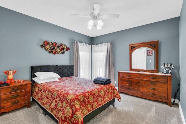 bedroom with ceiling fan and light colored carpet