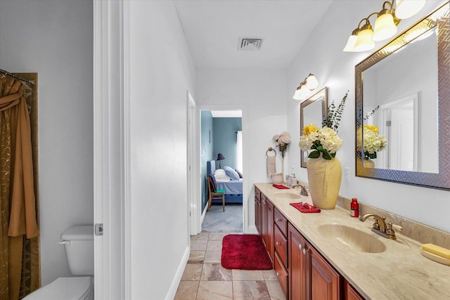 bathroom with vanity, toilet, and tile patterned flooring