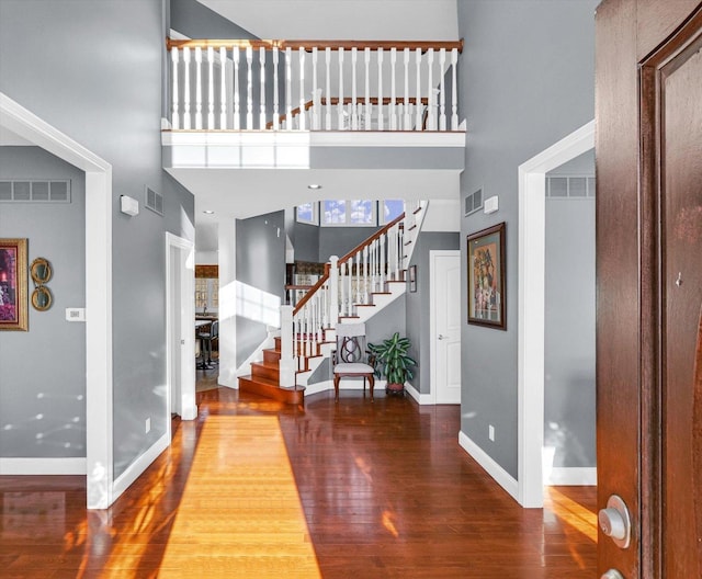 entrance foyer with hardwood / wood-style flooring and a high ceiling