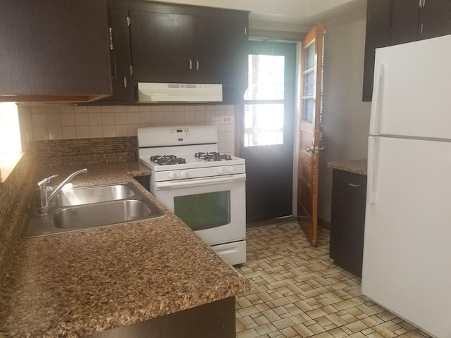 kitchen featuring sink, backsplash, and white appliances