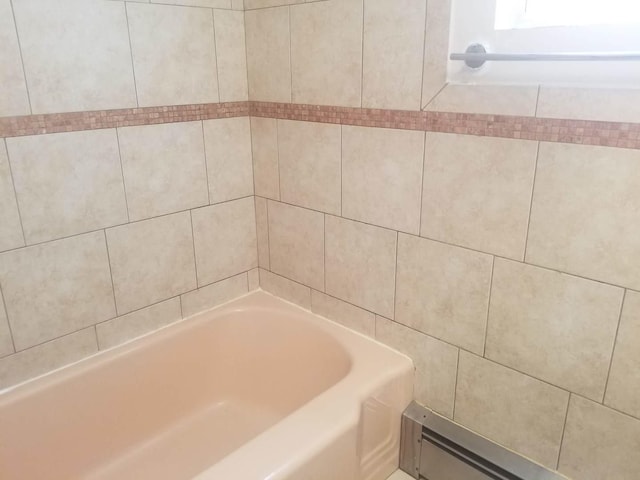 interior details featuring shower / washtub combination