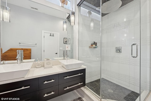 bathroom with a shower with door and vanity