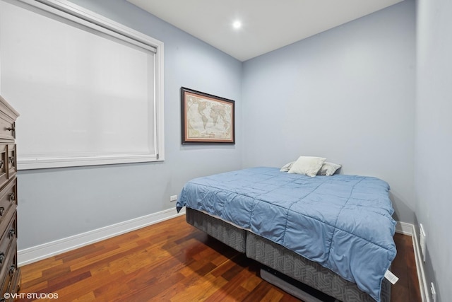 bedroom featuring dark hardwood / wood-style flooring