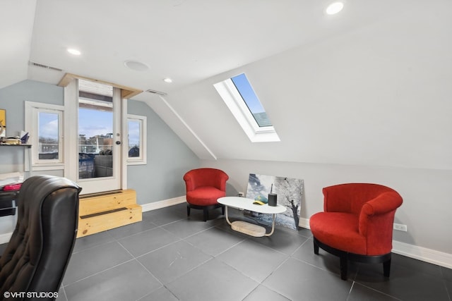 office space featuring lofted ceiling with skylight