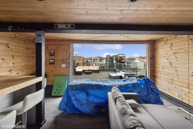 bedroom with wooden ceiling and wooden walls