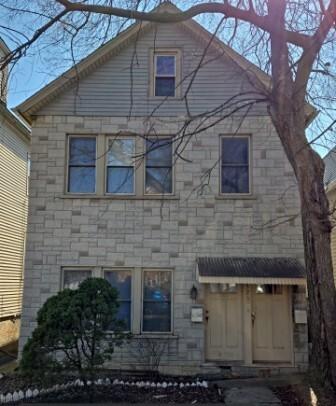 exterior space featuring stone siding