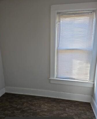 spare room with baseboards