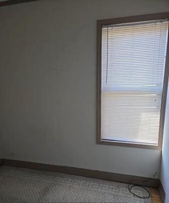 spare room with baseboards