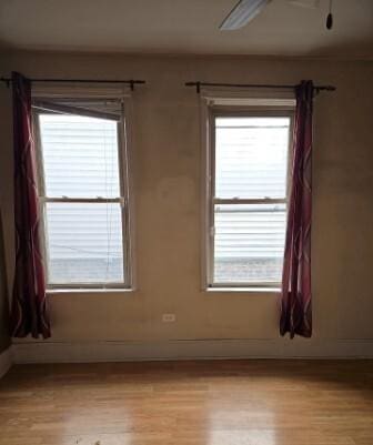 unfurnished room with baseboards and light wood-type flooring