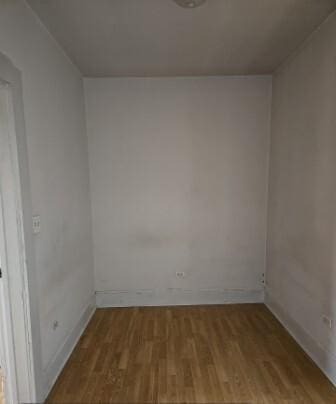 spare room featuring wood finished floors and baseboards