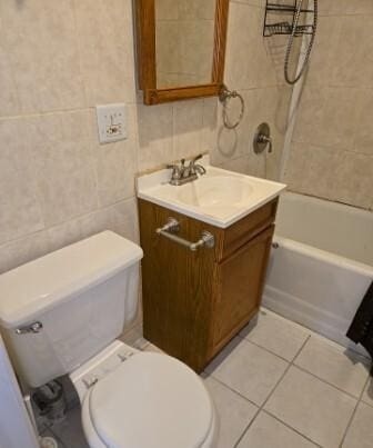 full bathroom featuring tile patterned floors, toilet, shower / tub combination, tile walls, and vanity