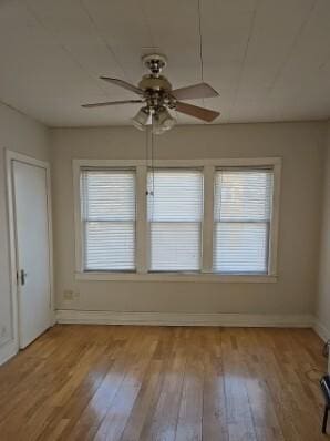 unfurnished dining area featuring light wood-type flooring, plenty of natural light, and baseboards