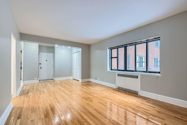 interior space with light wood-type flooring and radiator