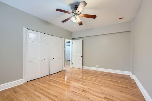 unfurnished bedroom featuring a closet, light hardwood / wood-style flooring, and ceiling fan