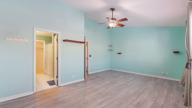 unfurnished bedroom featuring ceiling fan, vaulted ceiling, and light hardwood / wood-style flooring