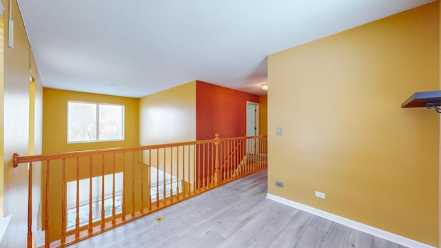 hallway with light hardwood / wood-style flooring