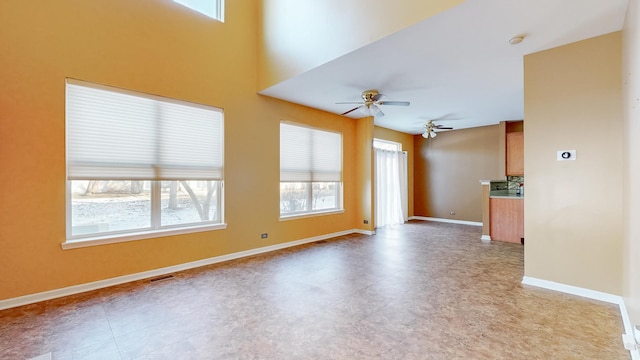 unfurnished living room with ceiling fan