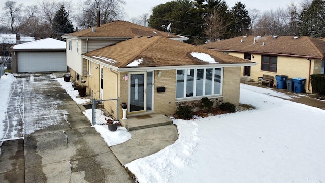 view of front of house featuring a garage and an outdoor structure