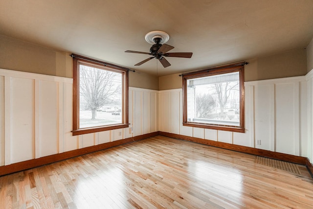 empty room featuring ceiling fan and light wood-type flooring