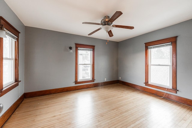 empty room featuring ceiling fan and light hardwood / wood-style flooring