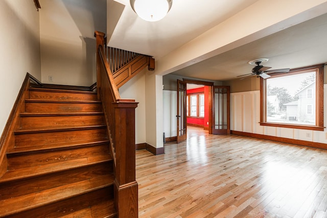 stairway featuring hardwood / wood-style flooring and ceiling fan