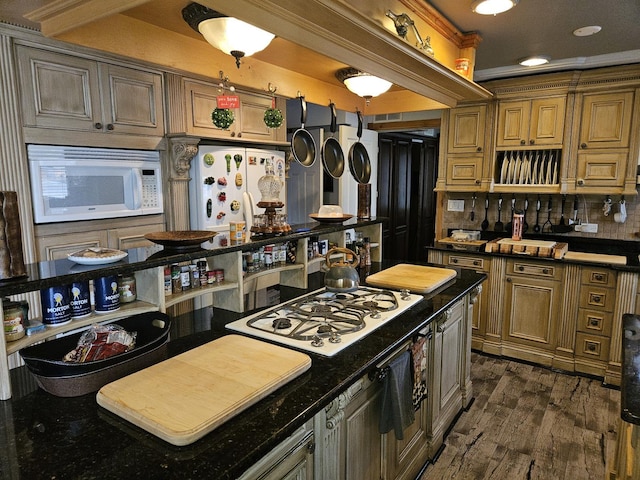 kitchen featuring backsplash, dark wood-type flooring, white appliances, and ornamental molding