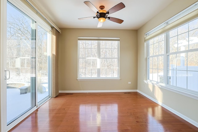 unfurnished room with ceiling fan and wood-type flooring