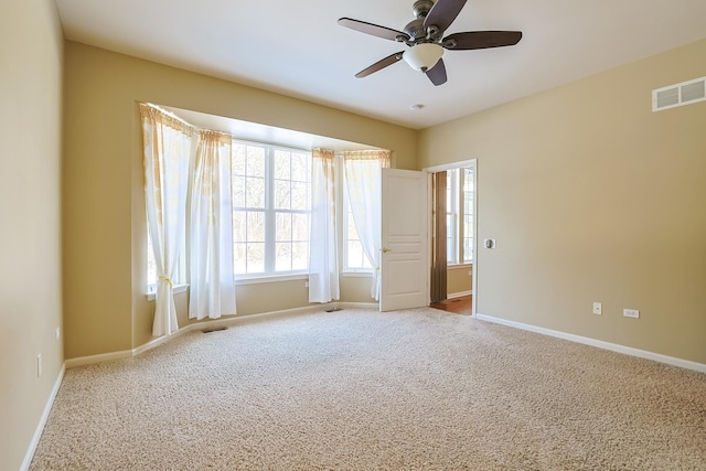 spare room with light carpet and ceiling fan