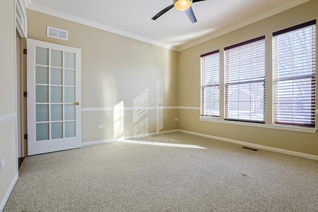 carpeted empty room featuring ornamental molding and ceiling fan