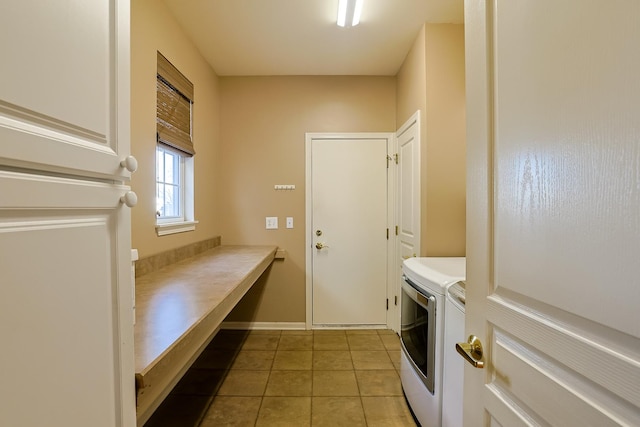 laundry room featuring washer and dryer and light tile patterned floors