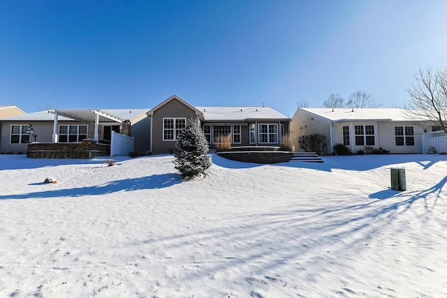 view of snow covered back of property