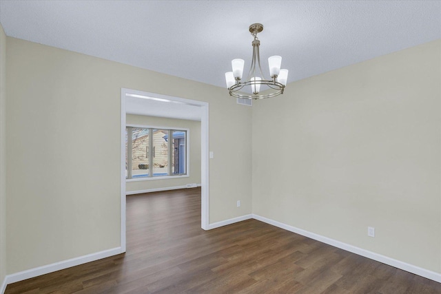 unfurnished dining area featuring dark hardwood / wood-style flooring and an inviting chandelier