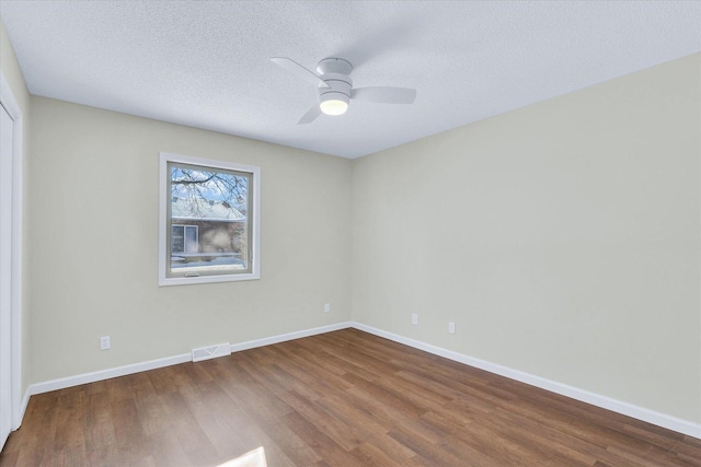 unfurnished room with hardwood / wood-style flooring, ceiling fan, and a textured ceiling