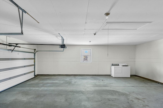 garage with a garage door opener and washing machine and dryer