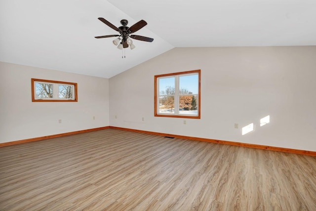 spare room featuring ceiling fan, vaulted ceiling, and light hardwood / wood-style flooring